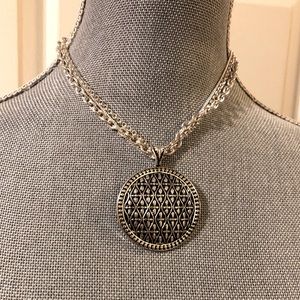 Silvertone necklace with round pendant
